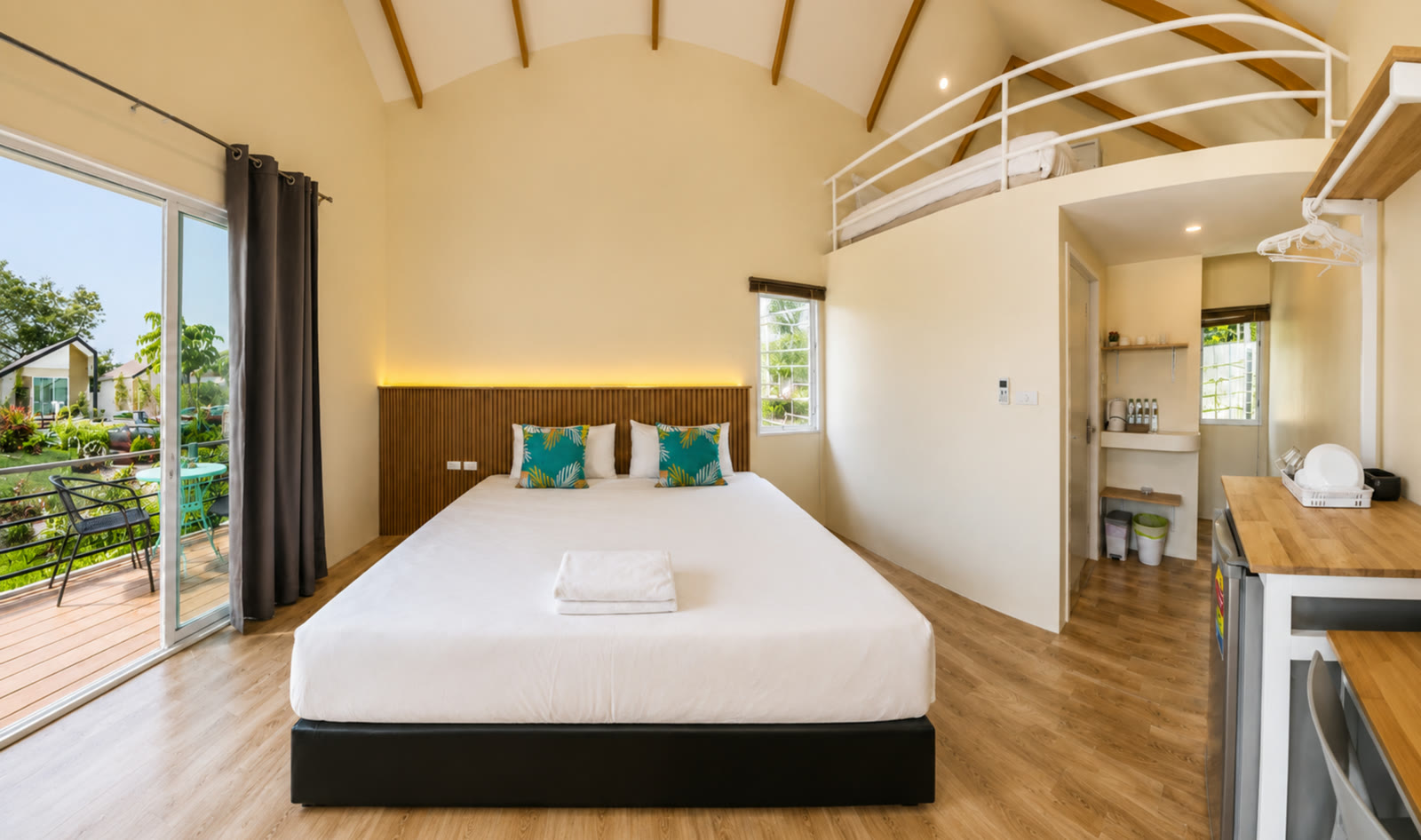 A-frame bedroom at NaraRin Phuket opening onto a private garden terrace